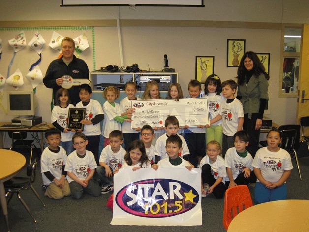 Mark Twain Elementary 1st graders smile for a photo Thursday after teacher