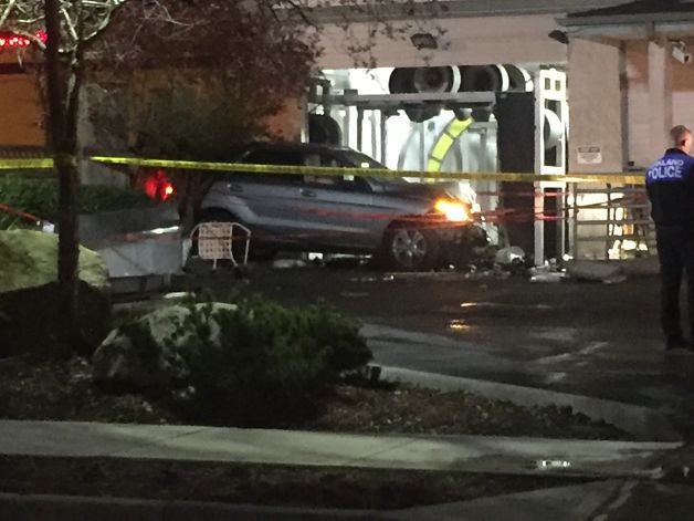 A woman in an SUV crashed through a fence and into a car wash in Kirkland on Wednesday night.