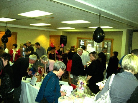 People browse auction items during the 9th annual Sibling House Fundraiser Auction at the Northshore Senior Center April 9.