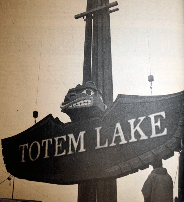 The first Totem Lake Malls' sign is hoisted into place near the lower mall and fit the Native American theme