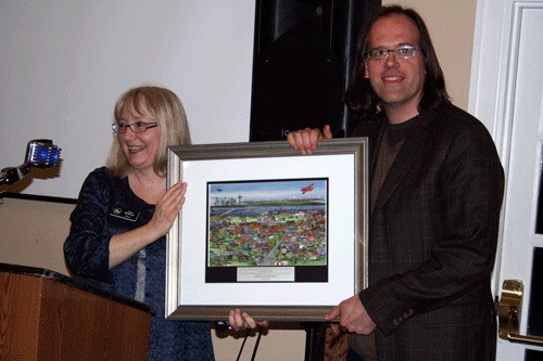 Creator of Northwest University’s Creatio music program Jeff Lockhart is honored with a plaque and photo during the Cultural Council’s Cachet Awards. Kirkland Mayor Joan McBride presented Lockhart with the award.