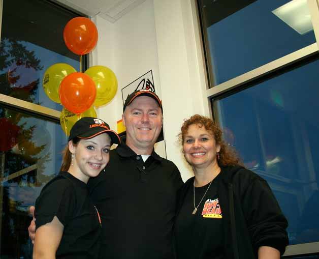 Kirkland residents Corey and Amy Freebairn opened their Little Caesars Pizza store on Wednesday at 12620 N.E. 85th St. in Kirkland. Also pictured is daughter Madeline