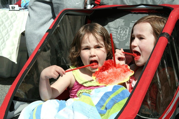 Kirkland resident Hadley Burns (right) shares some Oak Hills Farms Hawaiian Shave Ice with her sister