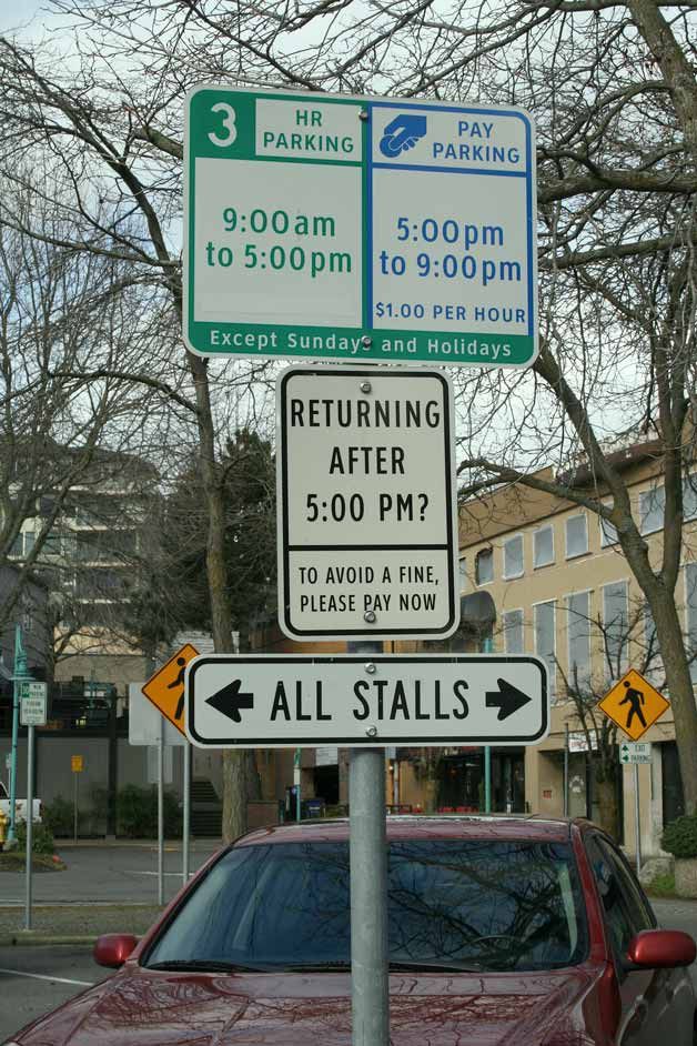 Parking signs like this one in the city-owned Marina Park parking lot instruct visitors to pay for parking between 5-9 p.m. Monday-Saturday