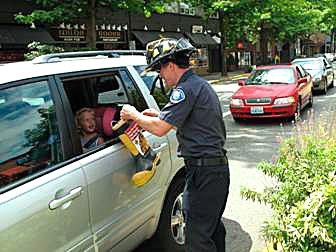 A Kirkland firefighter collects donations from a generous community member during a previous Fill The Boot event.