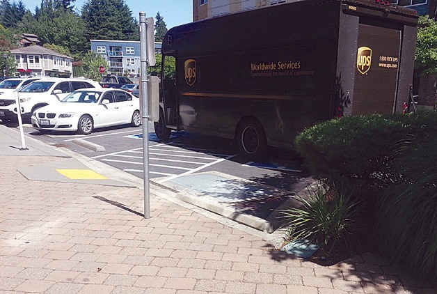 A UPS truck blocks two disabled parking spaces at Juanita Village on July 3.