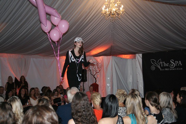 A model walks the runway during the Greater Kirkland Chamber of Commerce's Fall Fashion Show on Thursday evening in downtown Kirkland.