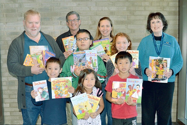 The Kiwanis Kirkland Sunrisers Club delivered books they purchased from Scholastica and Usborne Books to students at the John Muir Elementary School in Kirkland.