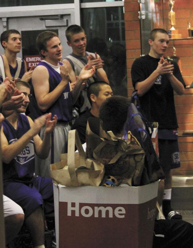 Members of the Lake Washington boys basketball team clap and welcome guests to the first annual Kang Maddness event