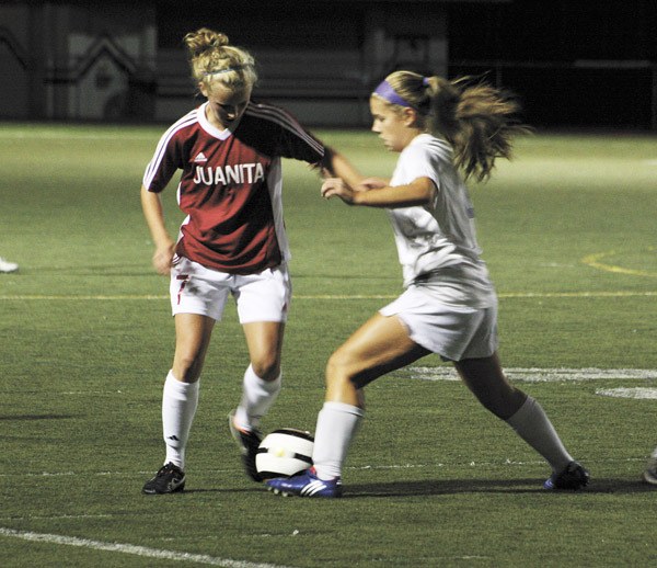 Juanita's Haili Adams tries to work the ball around Lake Washington's Emily Bunnell during the Kangs home win over the Rebels on Tuesday.