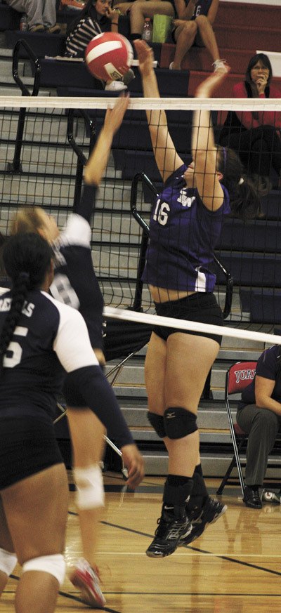 Lake Washington's Mackenzie Morgan (16) tips the ball back over the net to Juanita's Dana Michels during the Kangs loss to the Rebels last week.