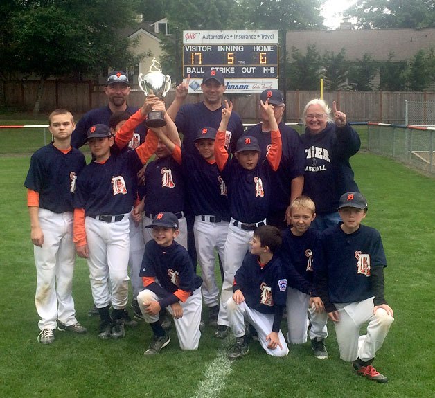 Members of the Tigers baseball team celebrate their KALL championship. Pictured are