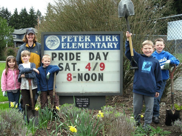 Peter Kirk Elementary students spruce up the school grounds with adult supervisor Bobbi Ostrum on April 9.