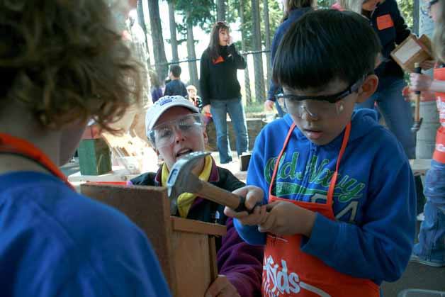 Juanita Elementary student Danny Lang pounds a nail into his new birdhouse