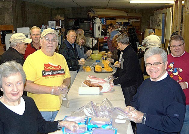 Kiwanis Club of Kirkland members pack sack lunches for hundreds of special kids for the Special Olympics King County 2013 Regional basketball tournament held in Issaquah on Feb. 10.