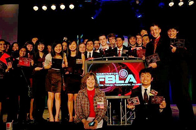 ICS FBLA members with their awards and their advisor