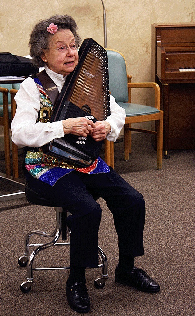 Italene Gaddis played her autoharp for residents of the Aegis Center in Kirkland during June.