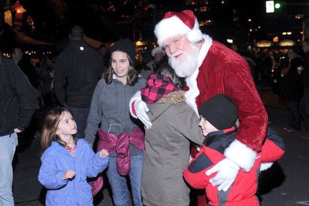 Santa Claus gives hugs during the downtown Kirkland Tree Lighting Ceremony in Kirkland in years past.