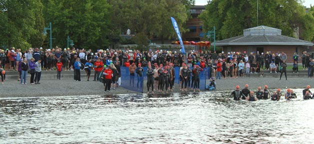 Hundreds of swimmers line the shore at Marina Park as they wait for the start time to jump into the first leg of the Kirkland Triathlon on Saturday.