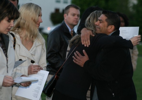 Solomon Metalwala hugs a friend Sunday night at Heritage Park in Kirkland