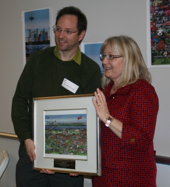 Executive Director Chris Shainin accepts the second annual CACHET Award on behalf of the Kirkland Arts Center from Kirkland Mayor Joan McBride Monday night at Northwest University.