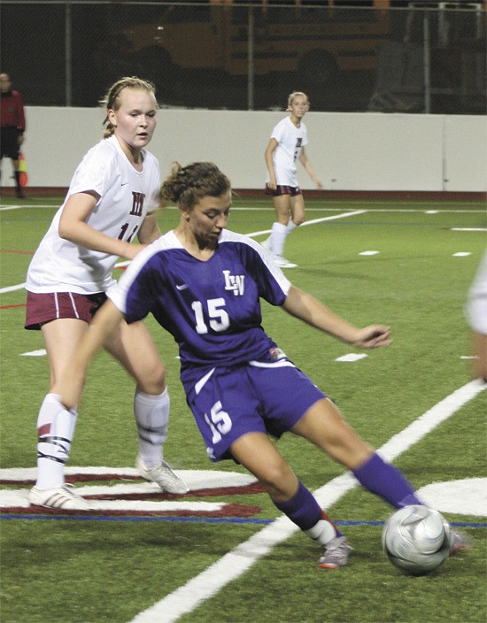 Lake Washington senior Jordan Masters works the ball through Mercer Island's centerfield dring the Kangs win over the Islanders last week. Masters' scored the Kang's first of two goals during the game for the 2-0 win.
