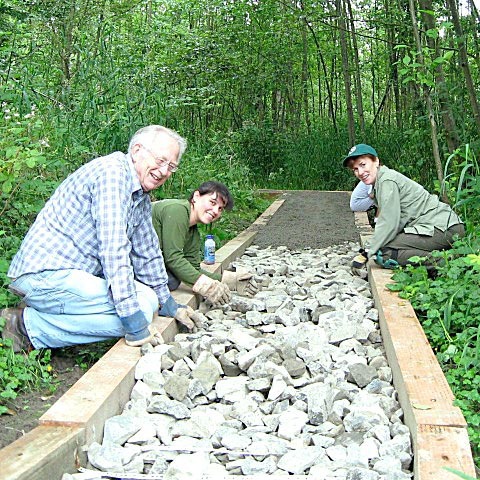 Trail architect Stu Clarke taught volunteers how to construct this raised gravel trail in Cotton Hill Park.