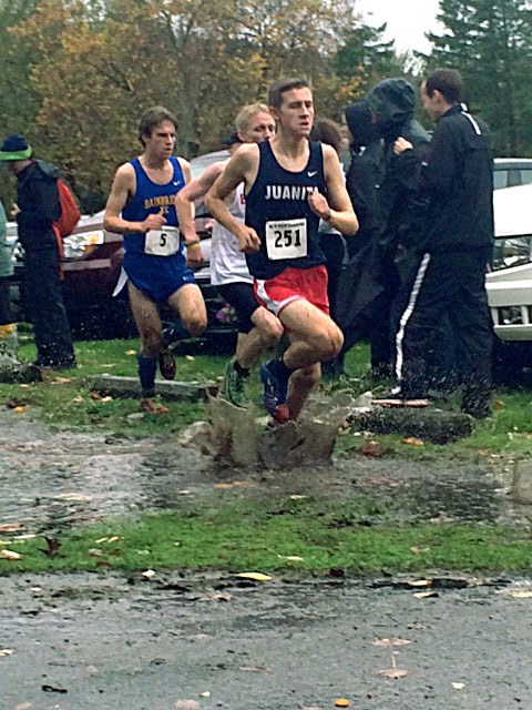 A Juanita High School cross country runner Nick Goodwin treks through the mud and rain on a sloppy Sammamish State Park course on Saturday.