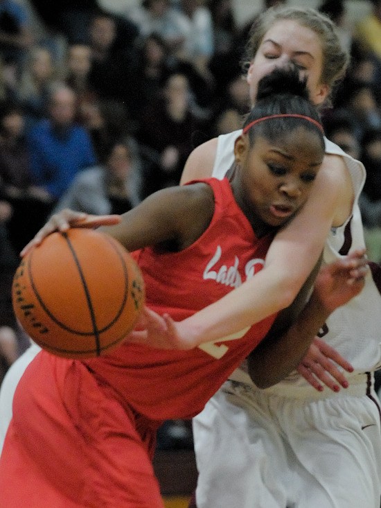 Rebel's Mikayla Jones (2) is fouled by an Islander defender at Mercer Island on Friday