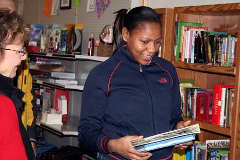 Hopelink worker Delaine Peterson  helps Beatrice Durr pick out two books during a visit to the Hopelink Gift Room Friday. Durr was one of over 1