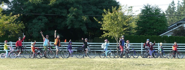 Parent Glen Buhlmann leads a group of Community School students and parents to school every morning via a bike caravan.