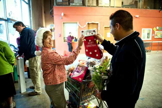 A client chooses some holiday gifts for his family at Hopelink in Kirkland.