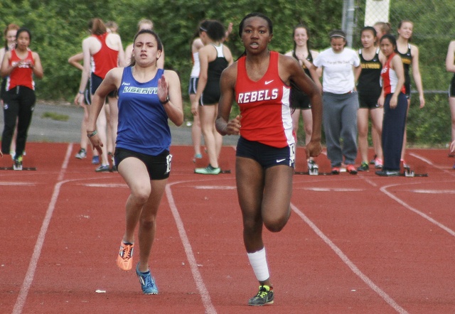 Juanita's Tamani Smart leads Maile Dillender of Liberty in the girls' varsity 100 meter dash on Thursday at Juanita High School. Smart won the race with a time of 13.38 seconds. JOHN WILLIAM HOWARD/Kirkland Reporter