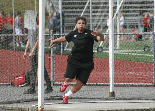 Juanita High junior Natayah Bauer prepares to hurl the discus during warm ups at practice on Tuesday