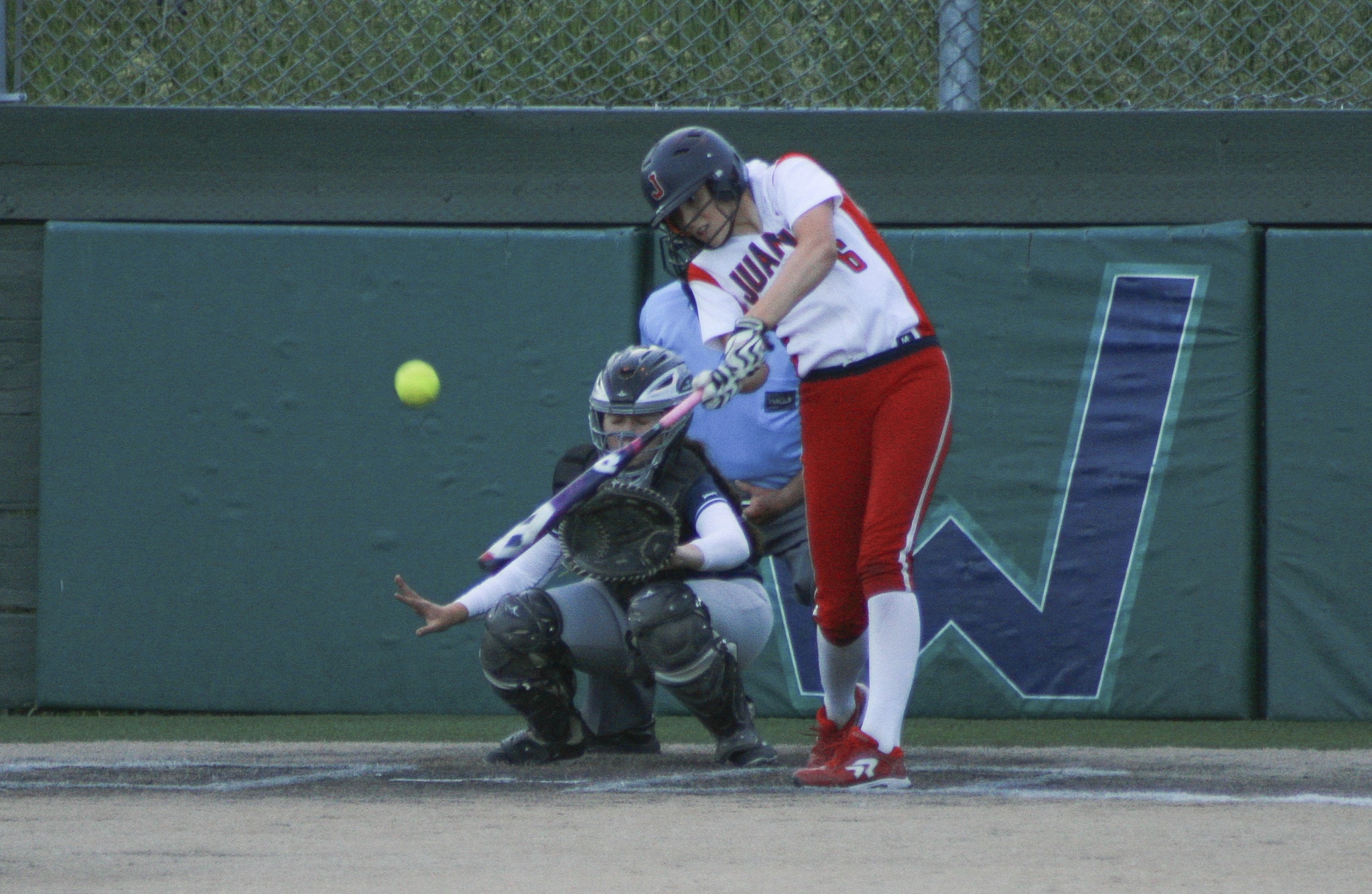 Juanita’s Kristna Warford swings at a pitch midway through the Rebels’ 7-4 win over Bellevue on Thursday at Woodinville High School. JOHN WILLIAM HOWARD/Kirkland Reporter