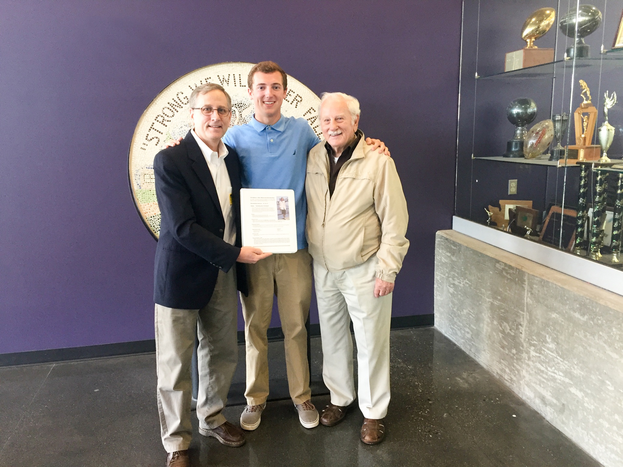 Spencer Burmester stands with Bob and Jim Neir of the Kirkland Heritage Society as they present the Lake Washington High School senior with a scholarship. Contributed photo