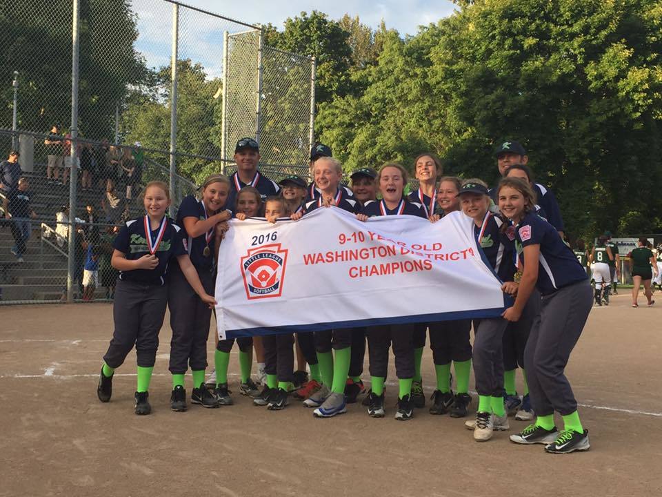 The Kirkland 9/10 All-Star softball team holds up the District 9 championship banner following the district title game on July 11. Kirkland will go for a state championship on July 21. Courtesy photo.