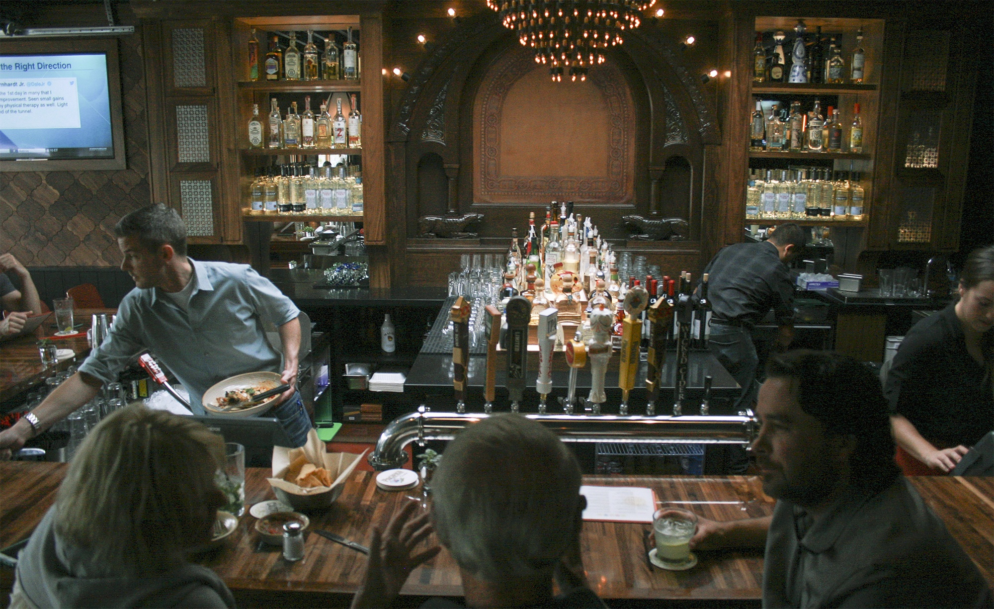 Guests sit at in the new bar section at Cactus