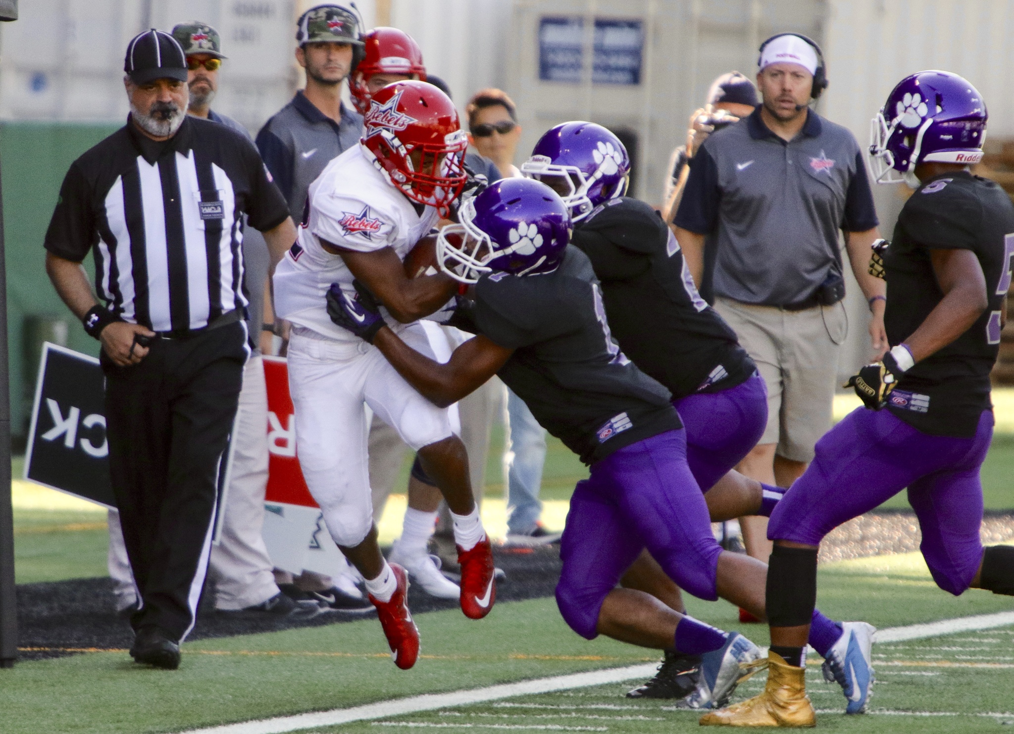 Juanita junior running back Andrez Trahan is shoved out of bounds by a pair of Garfield players during the Rebels’ 28-14 loss on Saturday at Memorial Stadium in Seattle. Trahan appears to be the stand-in while Juanita awaits the recovery of All-American Salvon Ahmed. Photo courtesy of Joe Byrne