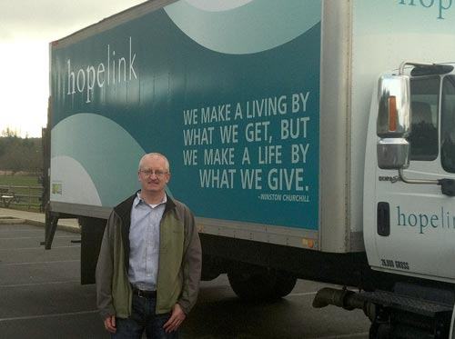 Seattle Travel Publisher Andrew Davis with the new Hopelink food bank truck donated to the organization by The Davis Fund.