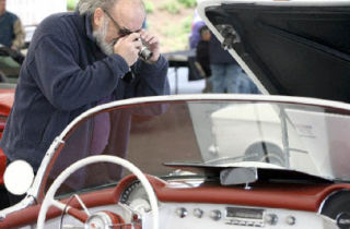 Katherine Ganter/Reporter Newspapers Dave Ramstad takes a photo of a car in the Lee Johnson collection at a classic “tri-five” car show at the Lee Johnson car dealership in Kirkland on May 10. The dealership is hosting a number of classic car shows and other events throughout the month of May for its 75th anniversary. Details and more information are available at www.leejohnson75years.com.