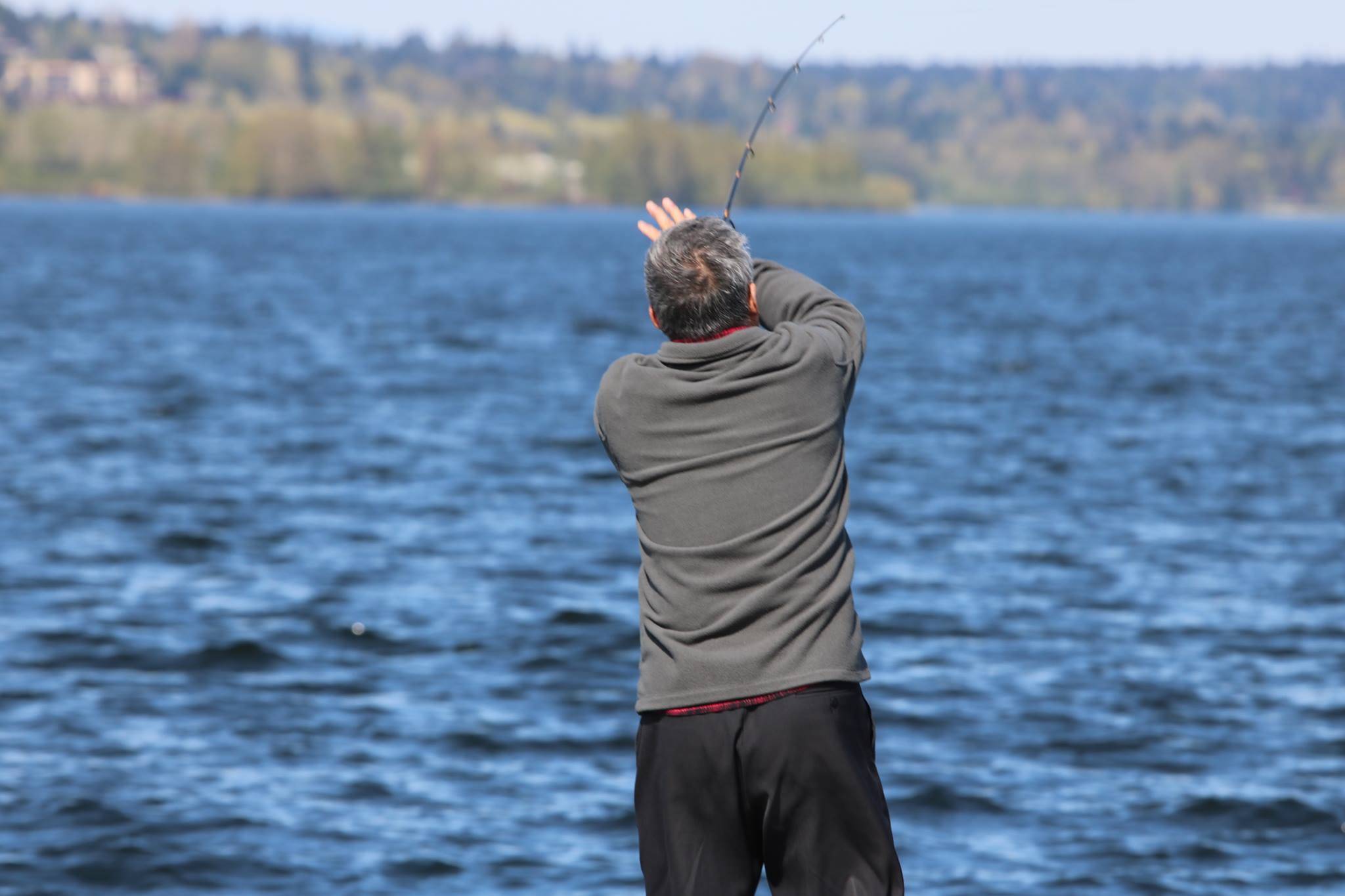 A man fishes off a dock at David E. Brink Park in Kirkland, 2018. Aaron Kunkler/Staff photo